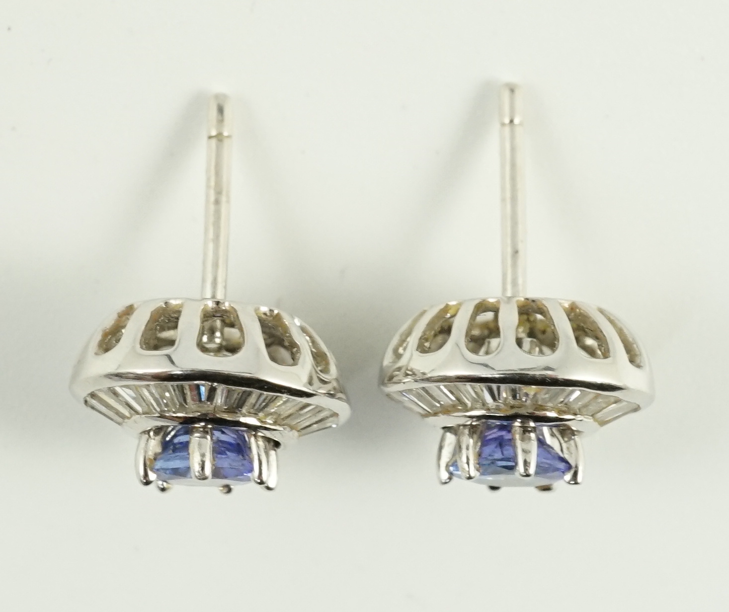 A modern pair of 750 white gold, tanzanite and diamond cluster set earrings